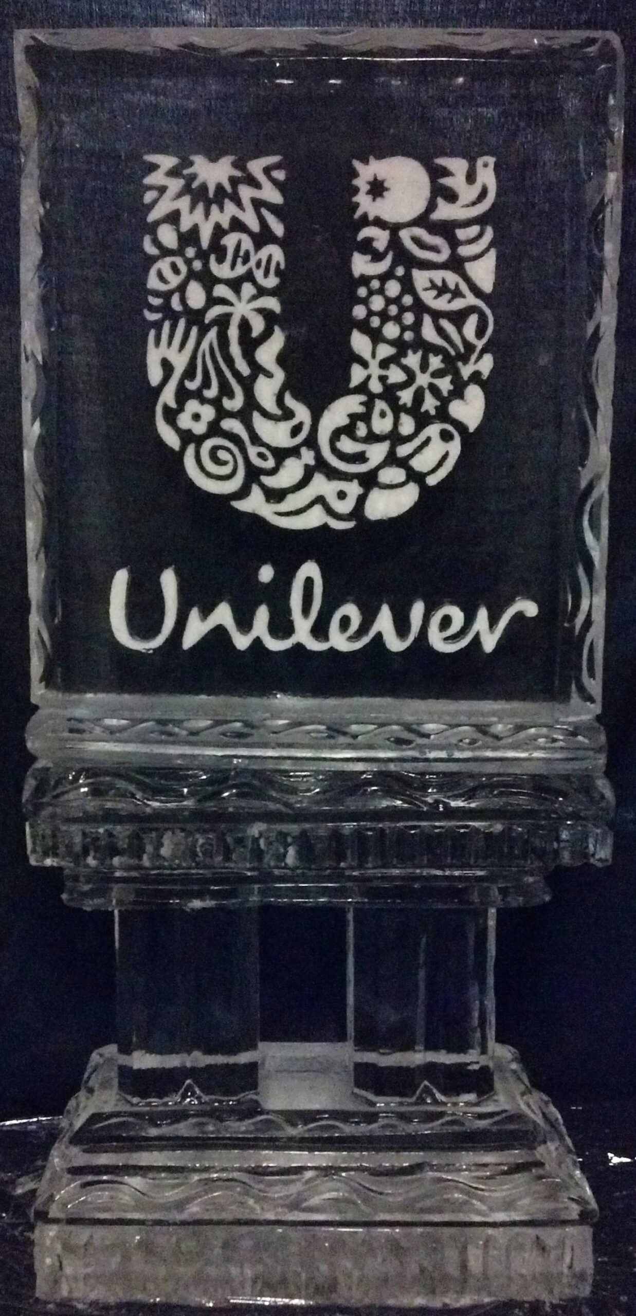 Unilever logo on a dark acrylic display stand