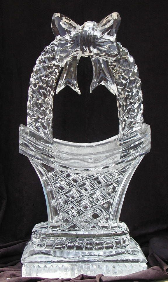 Clear crystal decorative ornament with a bow-like top on a black background
