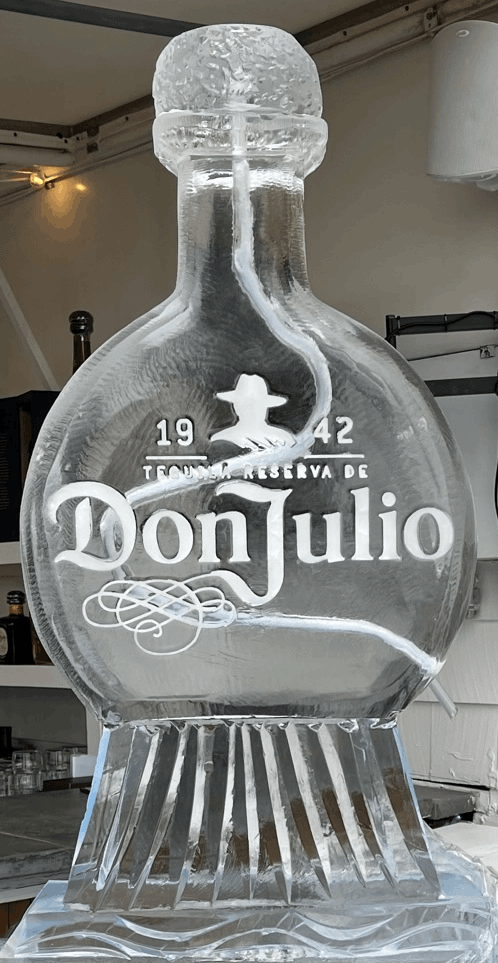 Clear Don Julio tequila bottle with frosted cap and ribbed base on a kitchen counter