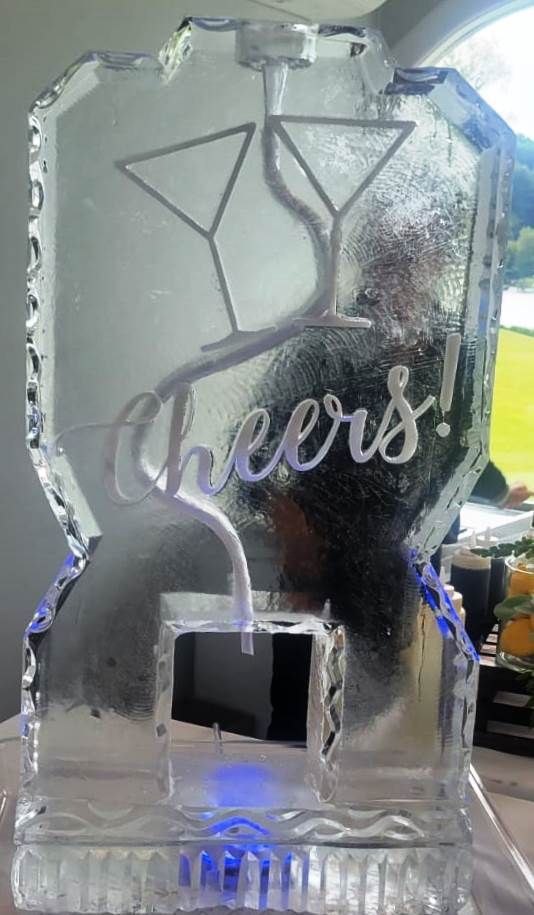 Frosted glass souvenir with clinking martini glasses and the word “cheers!” engraved on it
