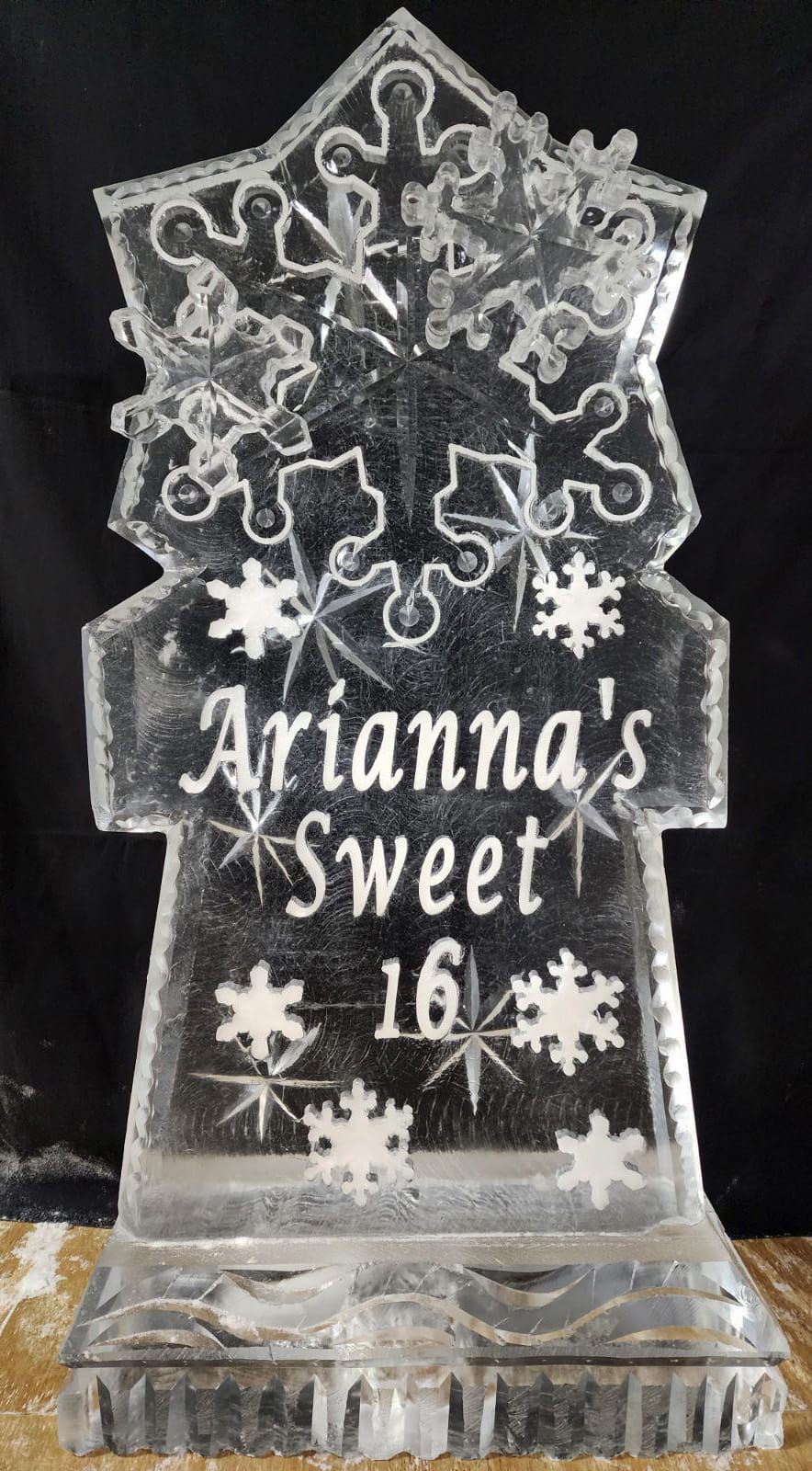 Clear acrylic “Arianna’s Sweet 16” plaque with snowflakes and snowmen on a black background