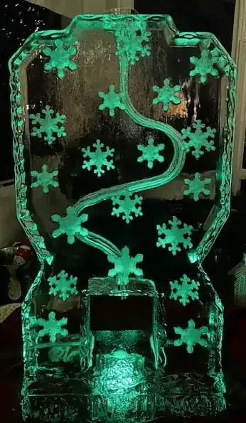 Glowing green snowflake ornament in a clear ice-like frame against a dark background