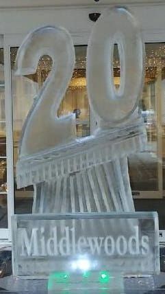 Clear “20” ice sculpture in a storefront window with “Middlewoods” sign below