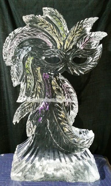 Clear glass owl sculpture with etched white and purple accents on a dark background