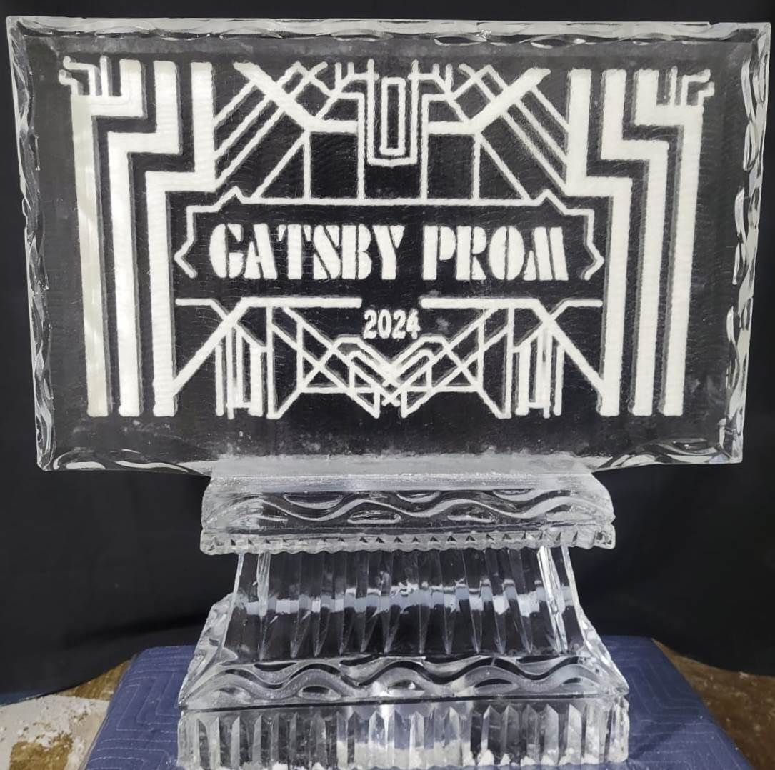 Art Deco-style trophy with “Gatsby Prom 2024” engraved on a black plaque atop a clear glass base.