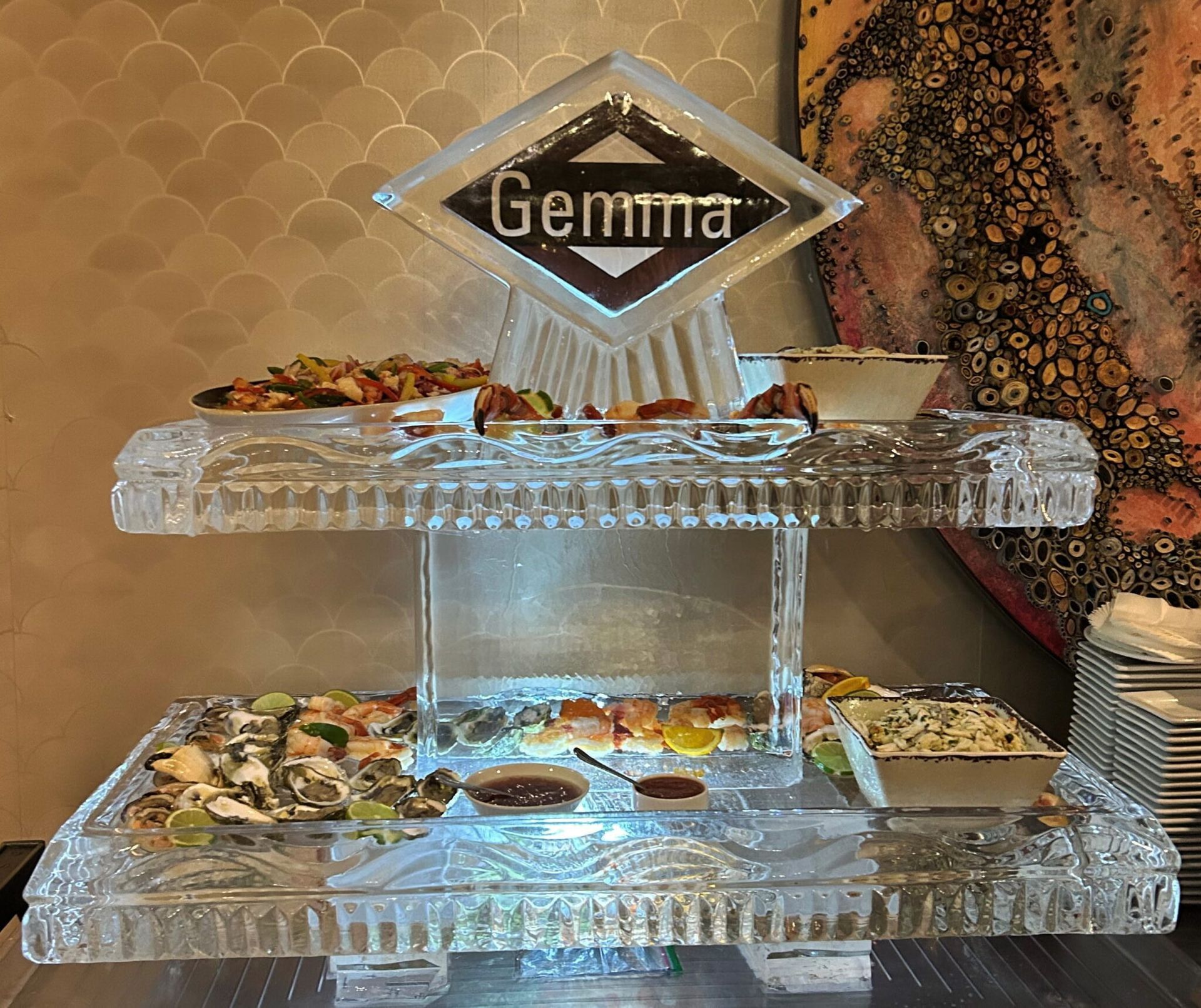 Crystal dessert buffet with the name “Gemma” on top, displaying assorted pastries and dishes on tiered trays