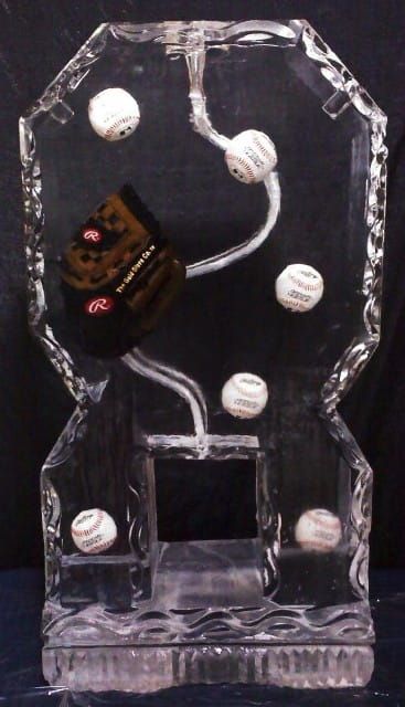 Clear crystal trophy with floating white golf balls and a black-and-gold emblem inside