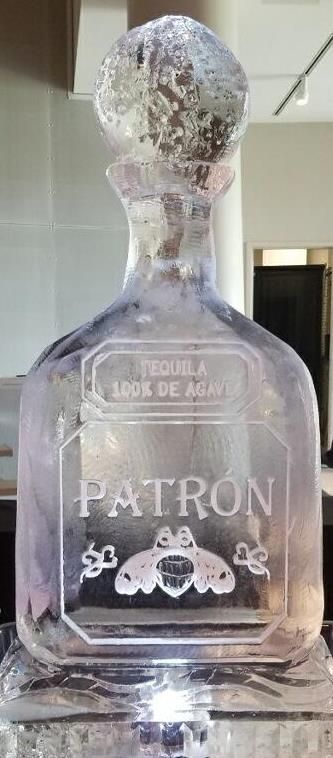 Frosted Patrón tequila bottle with a cracked top on a counter indoors