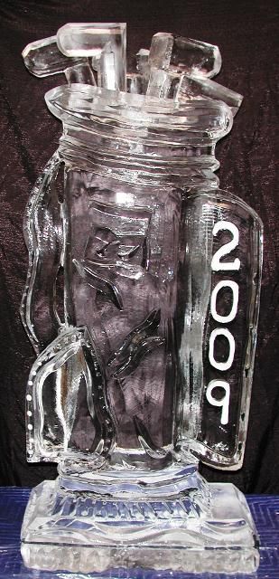 Clear glass chess-piece figurine with “2009” on the side, standing on a reflective base.