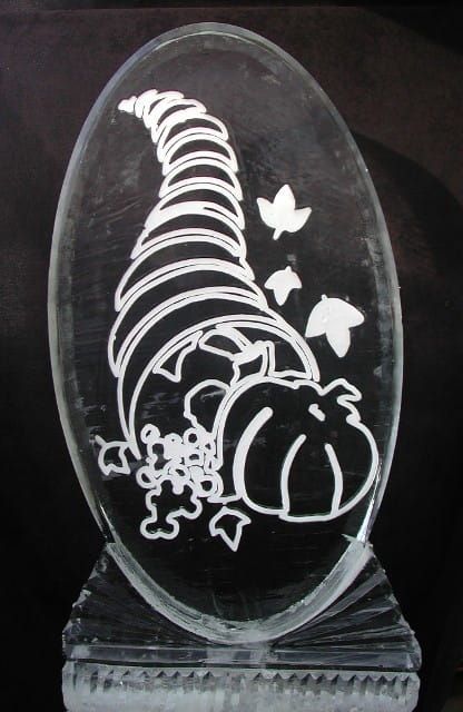 Clear oval glass plaque with white etched pumpkin, leafy vines, and butterflies on a dark base