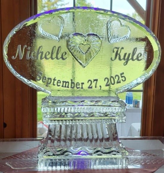 Engraved glass plaque with names Michelle and Kyle, heart design, and date September 27, 2025.