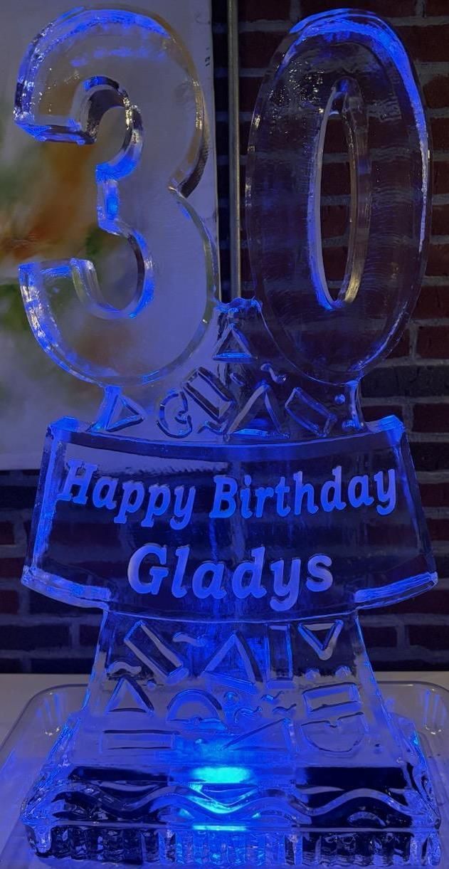 Blue-lit 30th birthday ice sculpture with “Happy Birthday Gladys” engraved on the base