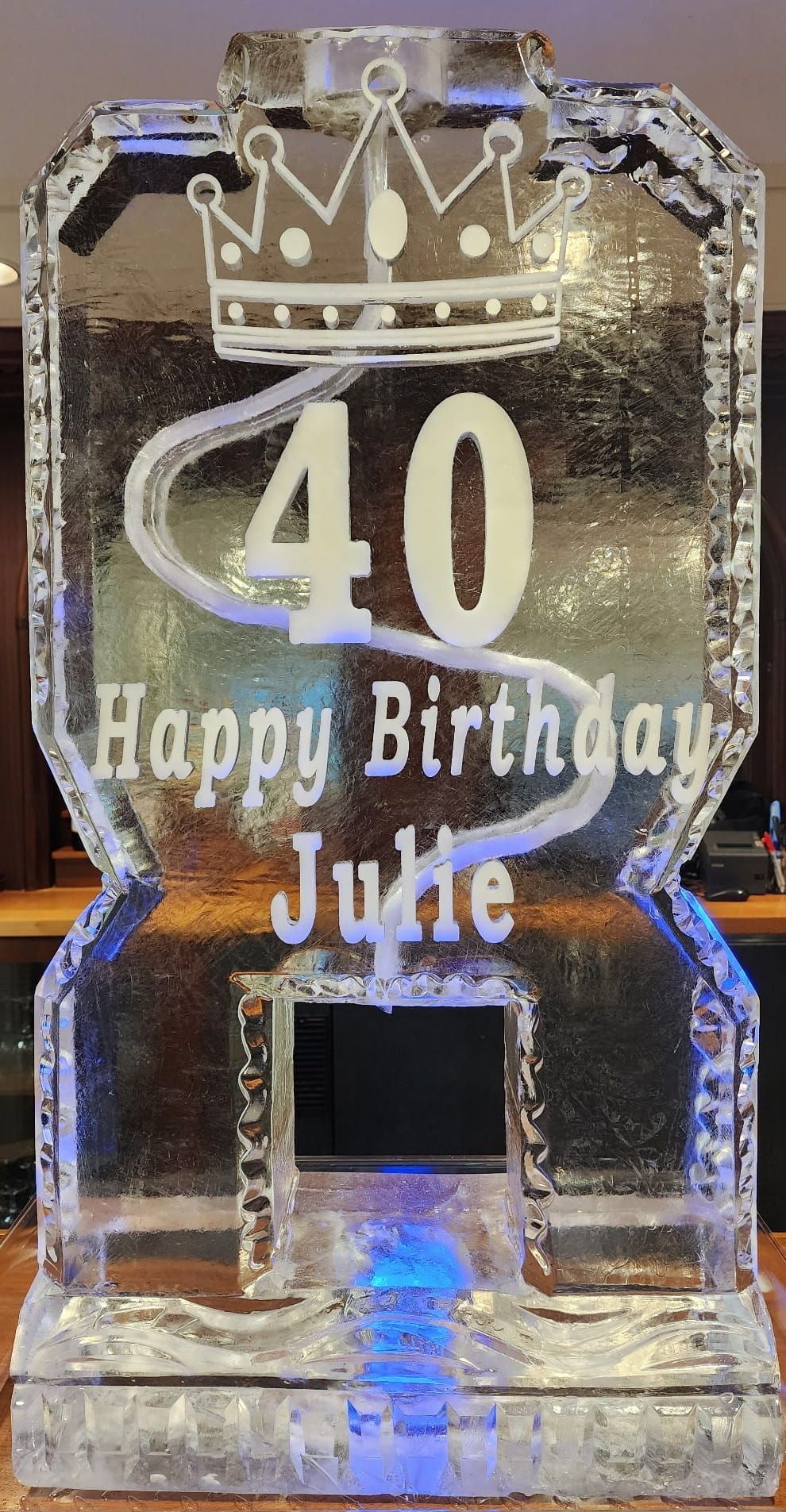 Clear engraved “40 Happy Birthday Julie” glass award with crown design and blue light base