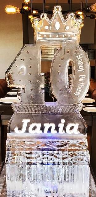 Glowing crystal 40th birthday cake topper with a crown and the name “Jania” on a decorated cake