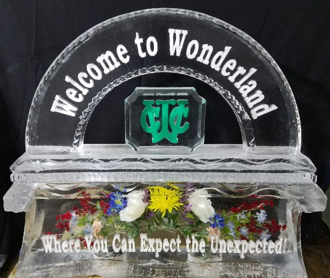 Welcome to Wonderland sign with flowers and the quote “What You Can Expect the Unexpected.”