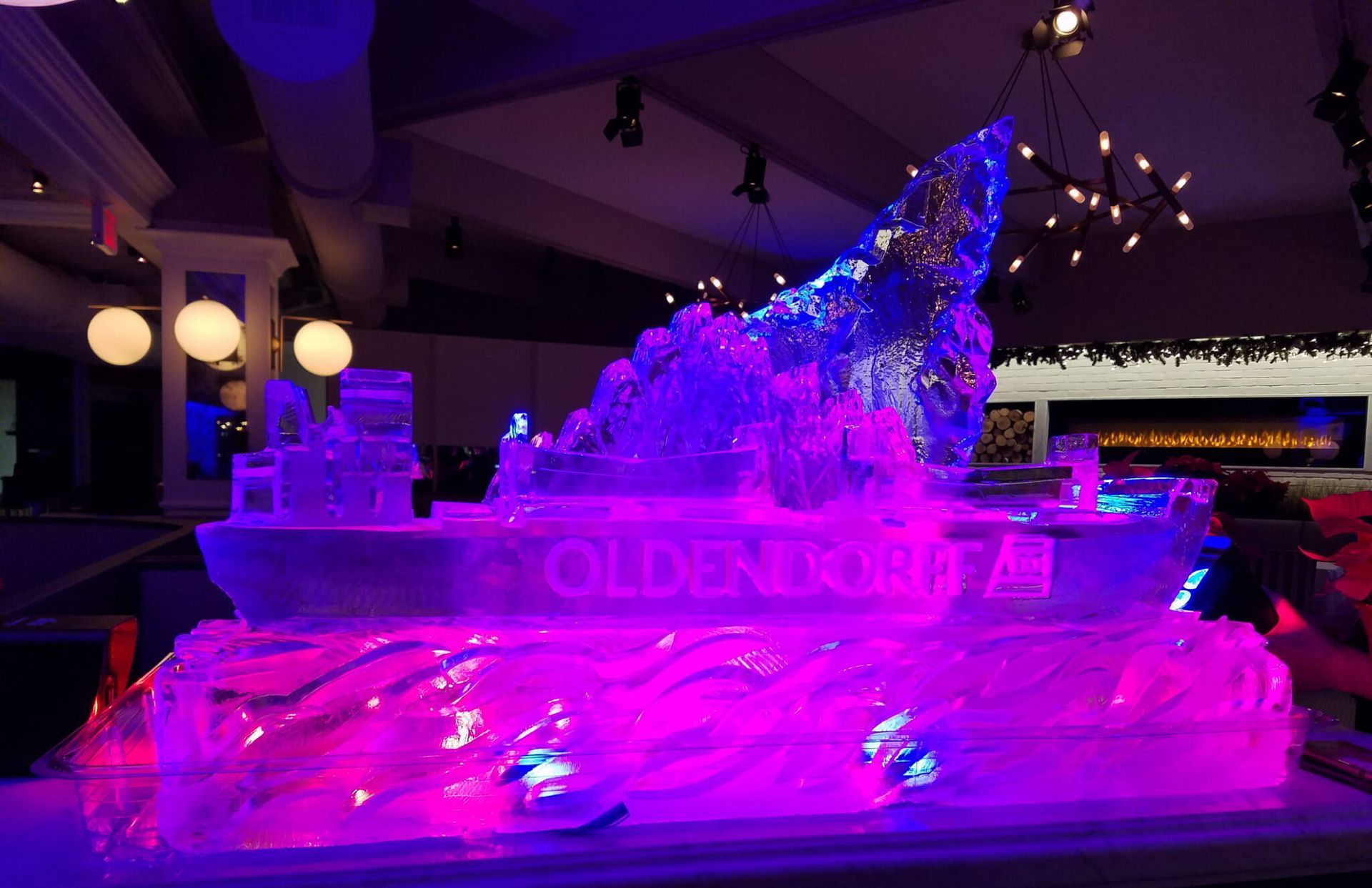 Purple and pink ice sculpture display at an indoor event venue