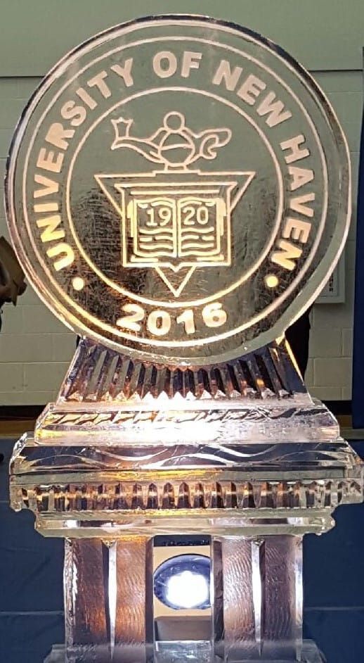 University of New Haven gold award plaque with circular emblem and 2016 date on a pedestal