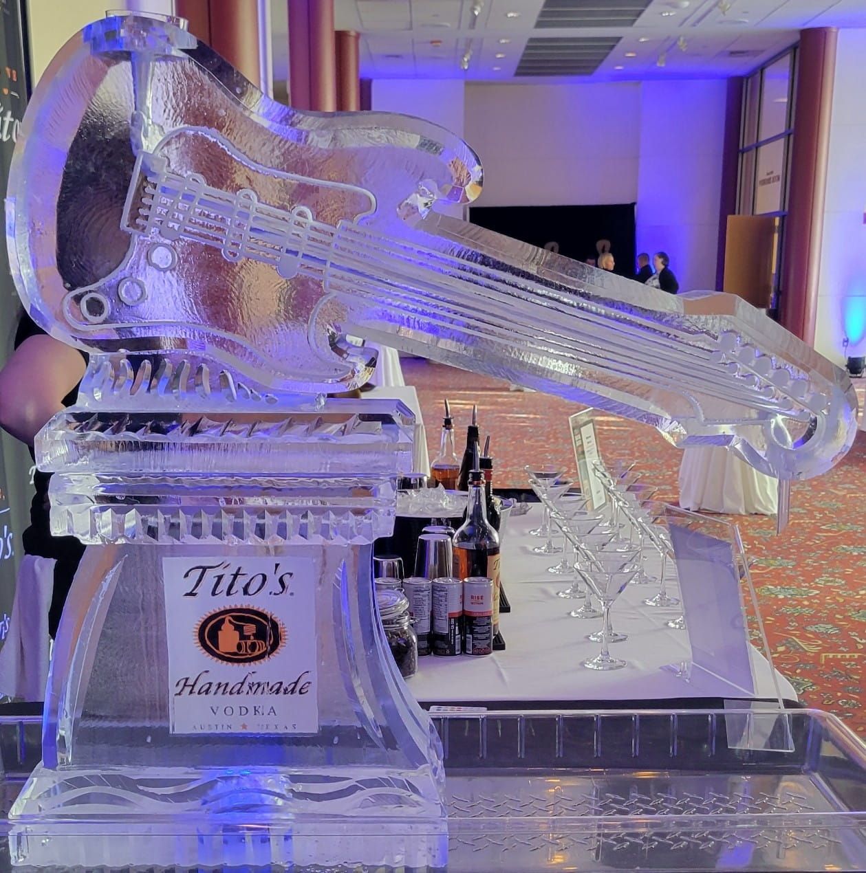 Ice sculpture of a guitar on a Tito’s vodka display at an indoor event