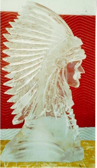 Clear glass Native American chief bust with feathered headdress on red and white background