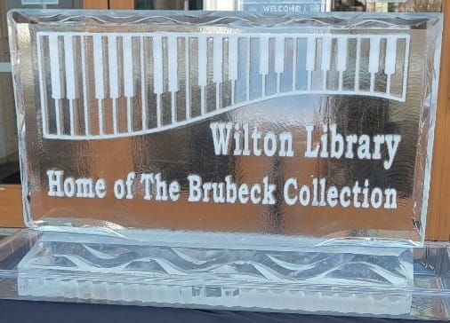 Glass sign reading “Wilton Library, Home of The Brubeck Collection”