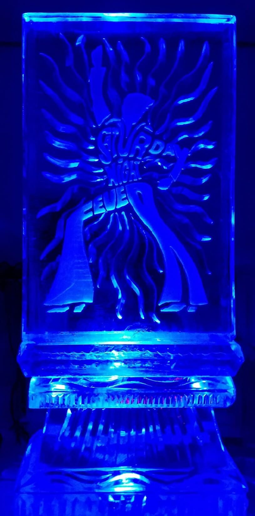 Blue glass candleholder with an etched sunburst and figure design