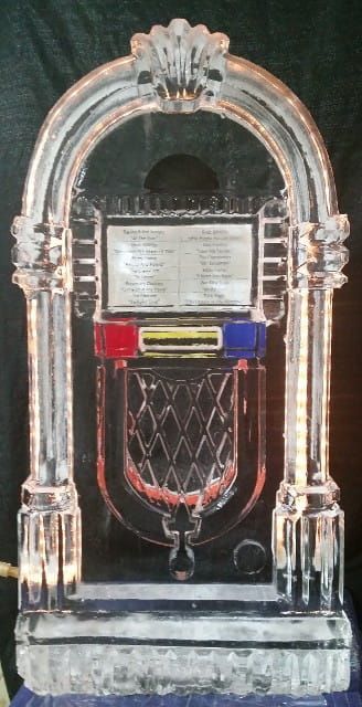 Vintage jukebox with chrome arch, red and blue buttons, and diamond-pattern speaker grille