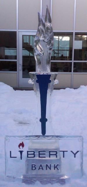 Liberty Bank sign in front of a snowy building with a tall ice sculpture