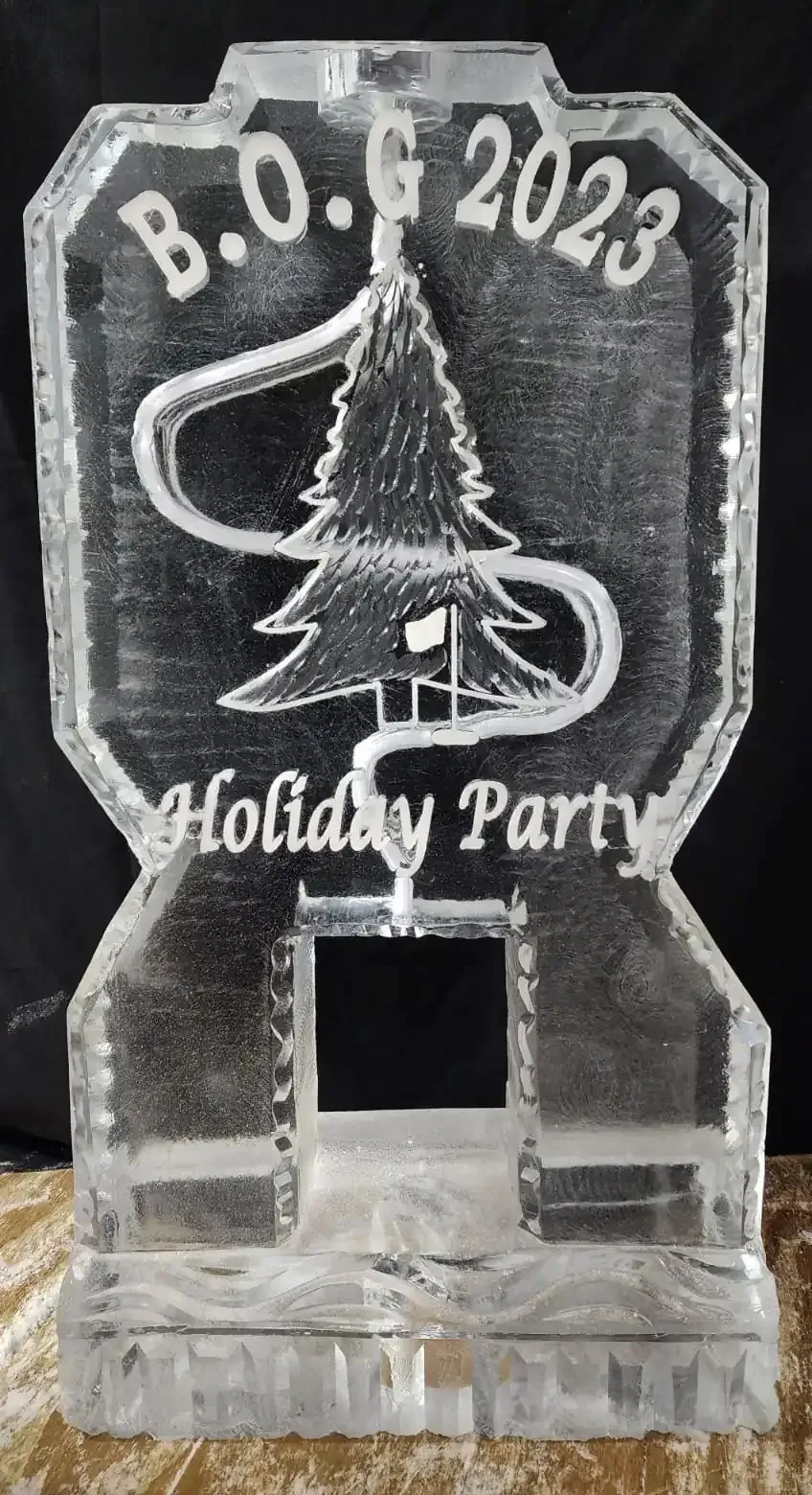 Clear engraved acrylic holiday party award with a Christmas tree and “B.O.E 2023” text