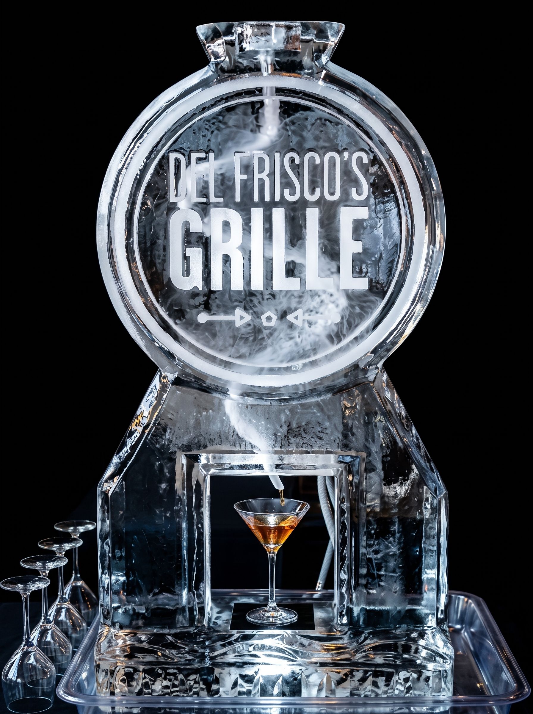 Clear bottle-shaped display with “Del Fisco Grille” logo and a small martini glass inside