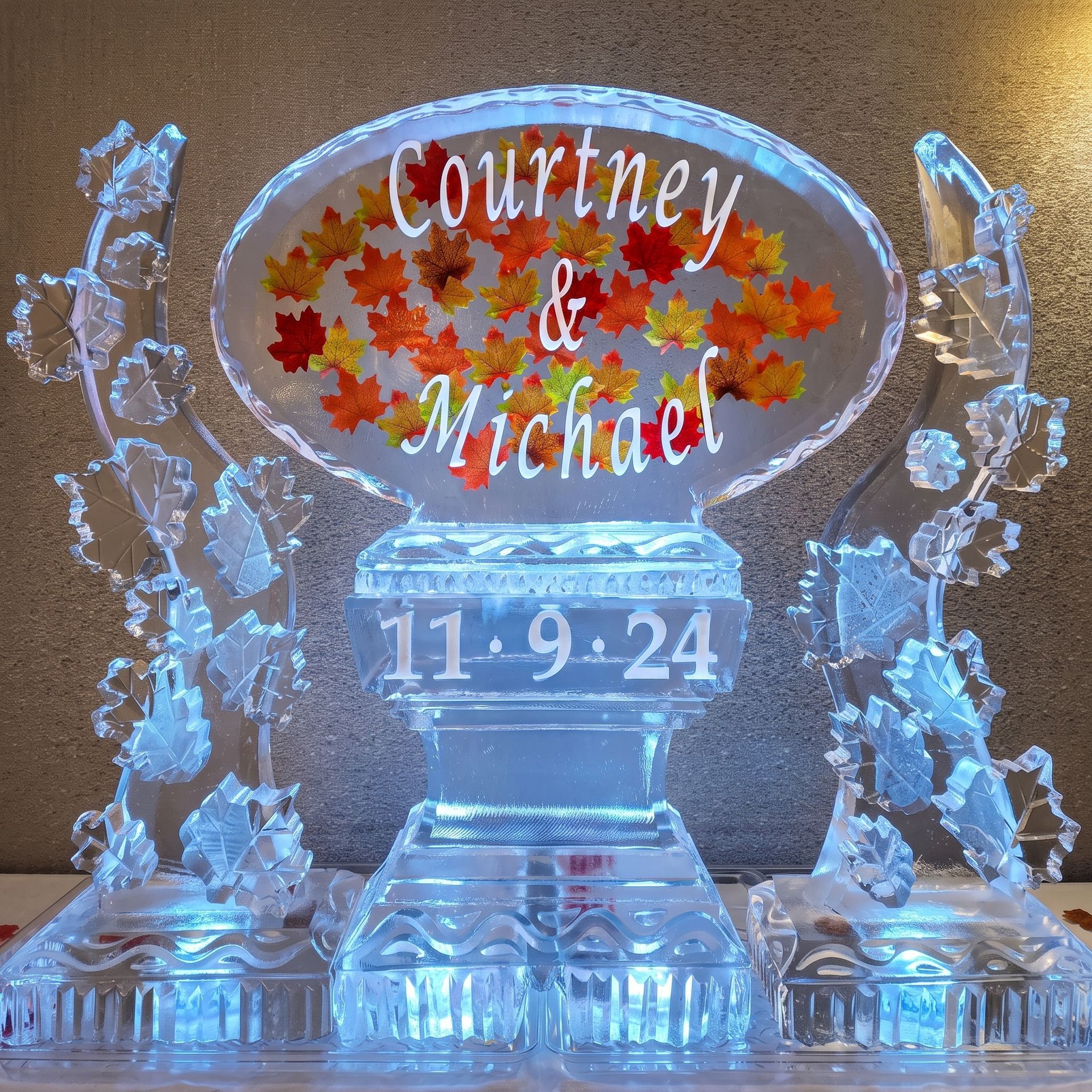 Engraved ice sculpture with autumn leaves and names Courtney & Michael, dated 11-9-24