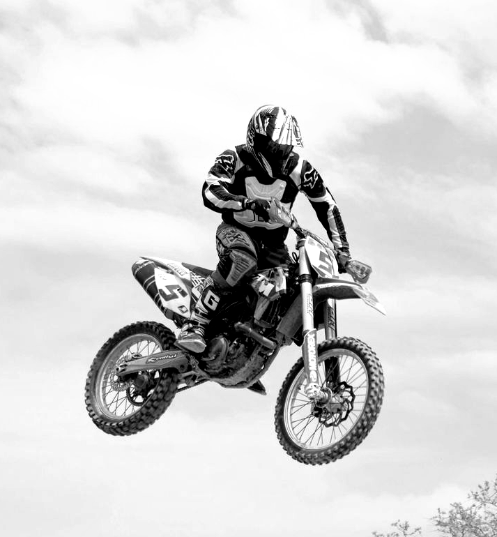Motocross rider in mid-air, black and white photo. Number 11 on bike.