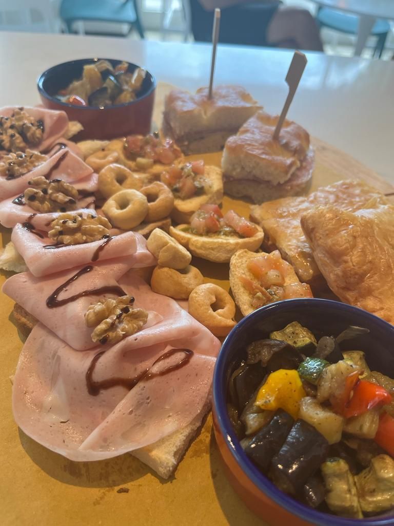 chopping board with mortadella, caponata