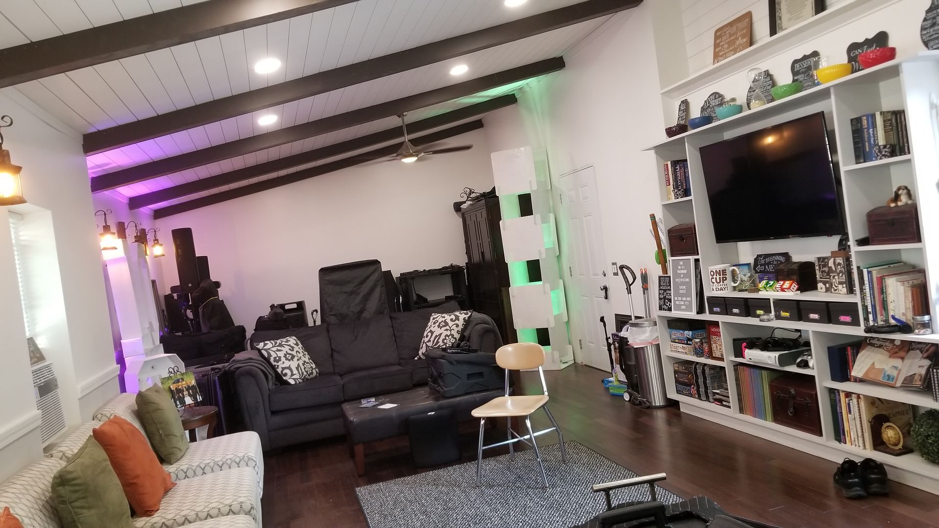 A living room filled with furniture and a television.