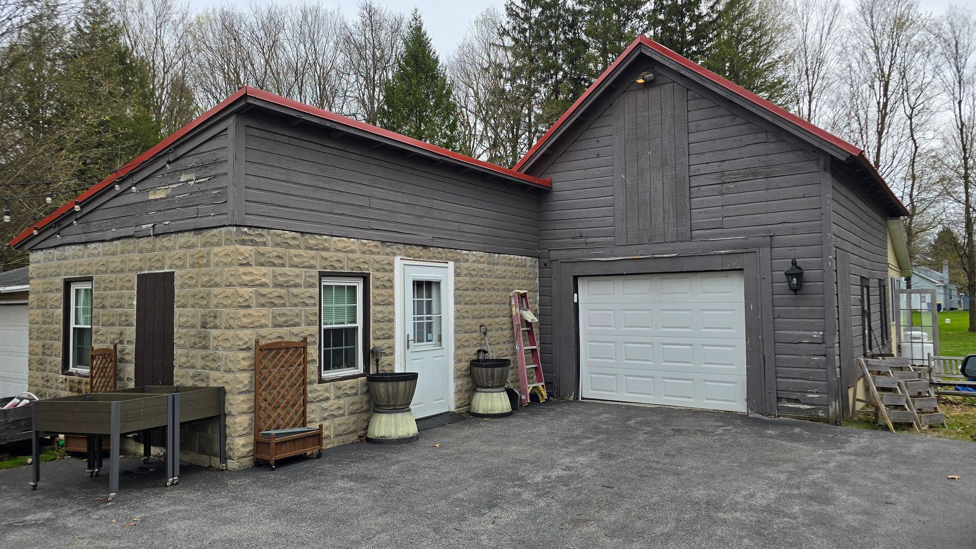 A brick house with a garage and a red roof