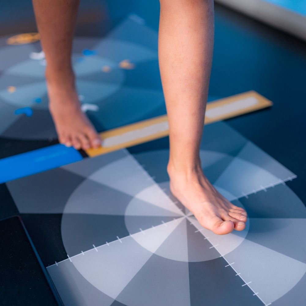 A Person's Feet Are Standing On A Checkered Mat — Mooloolaba Foot Centre In Mooloolaba, QLD