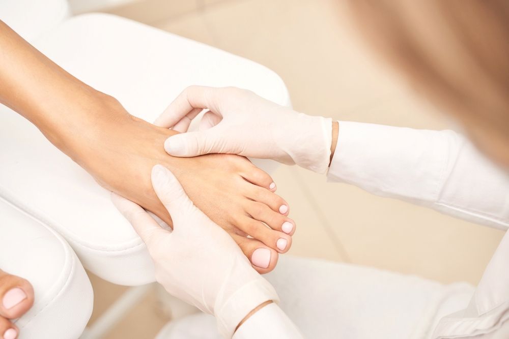 A Woman Is Getting Her Feet Examined By A Doctor — Mooloolaba Foot Centre In Mooloolaba, QLD