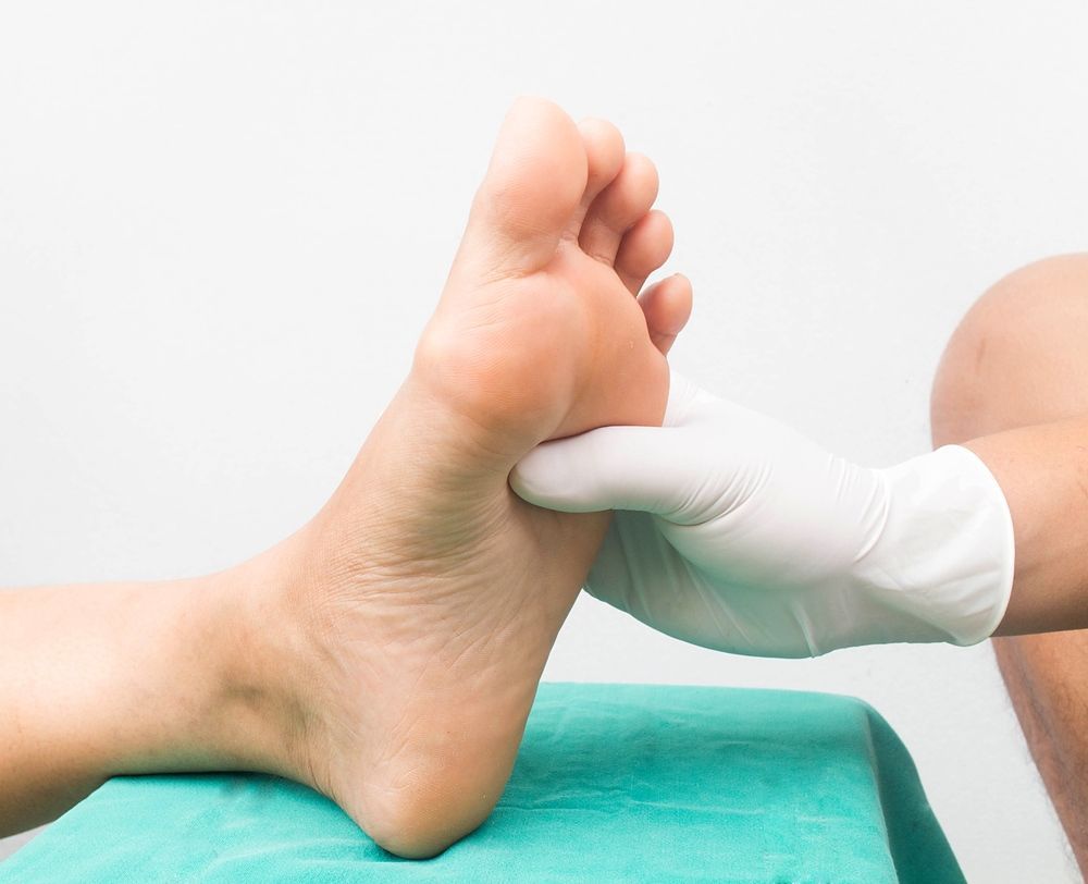 A Person Is Getting Their Foot Examined By A Doctor — Mooloolaba Foot Centre In Mooloolaba, QLD