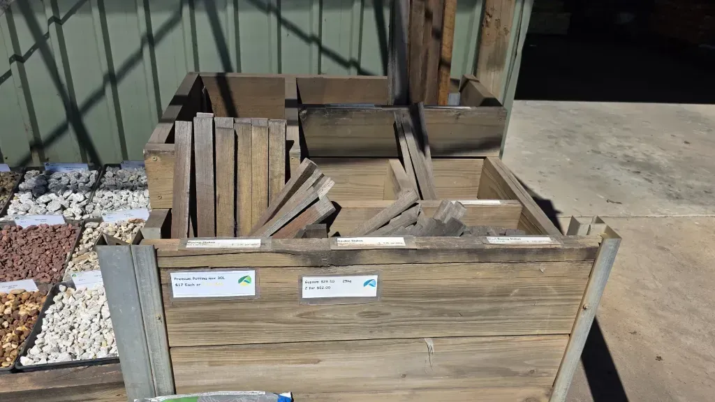 A wooden box filled with a variety of pieces of wood and rocks.