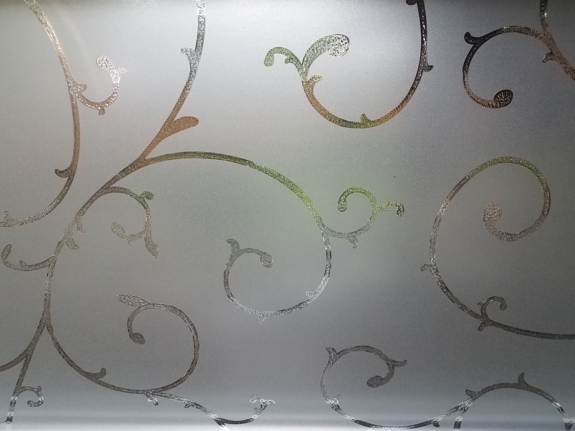 White wallpaper with gold and gray swirling floral vine pattern