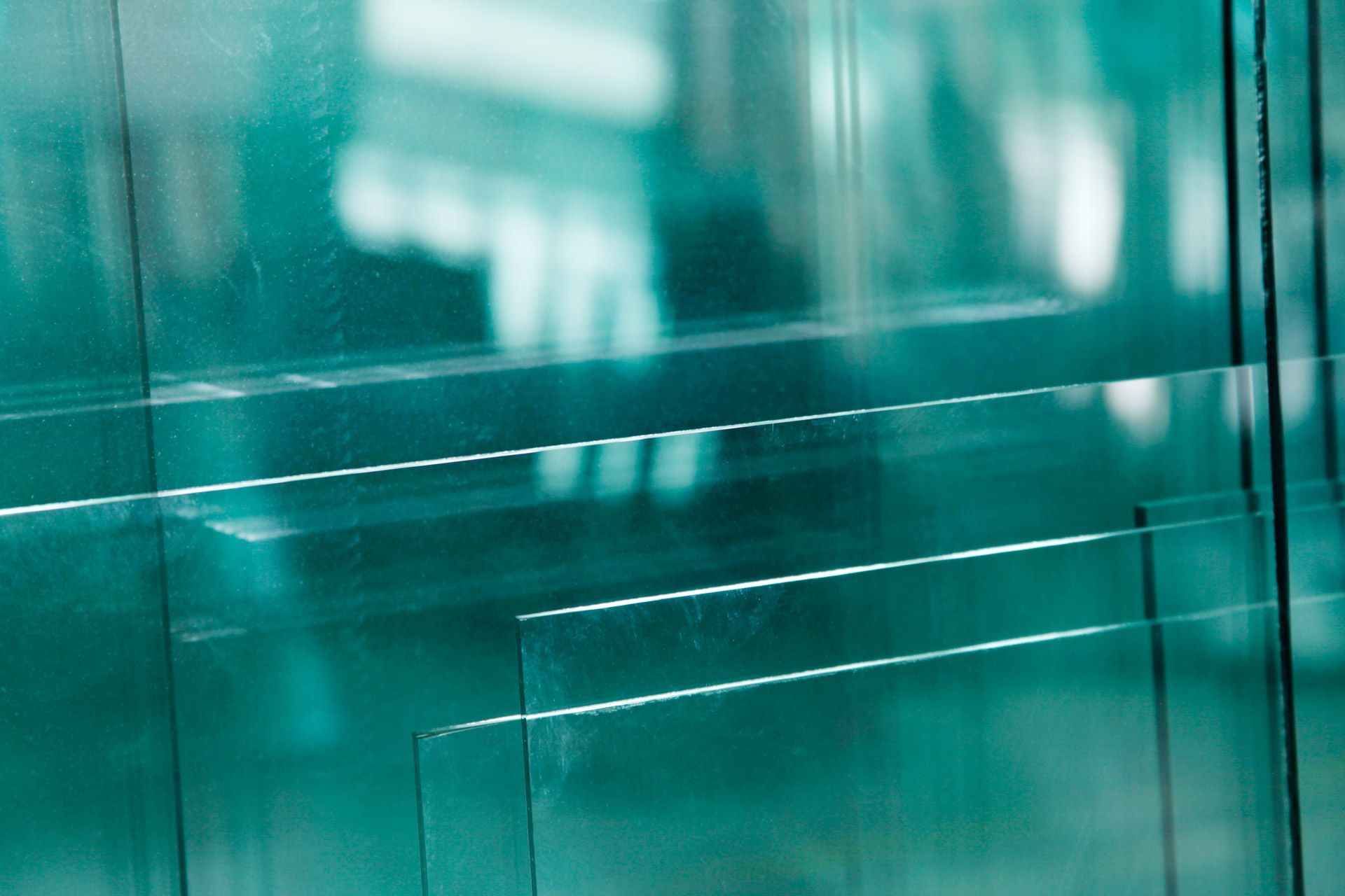 Abstract teal glass panels with reflections and thin white lines