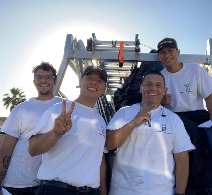 A group of men are posing for a picture with a ladder in the background A group of men are posing for a picture with a ladder in the background