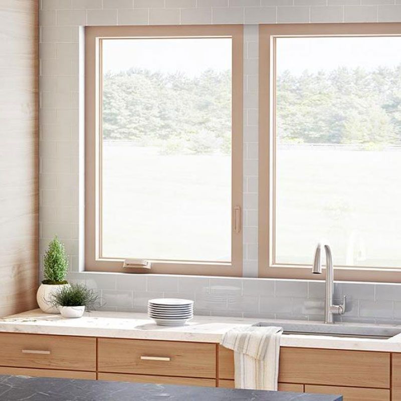 A kitchen with a sink , two windows , and wooden cabinets. A kitchen with a sink , two windows , and wooden cabinets.