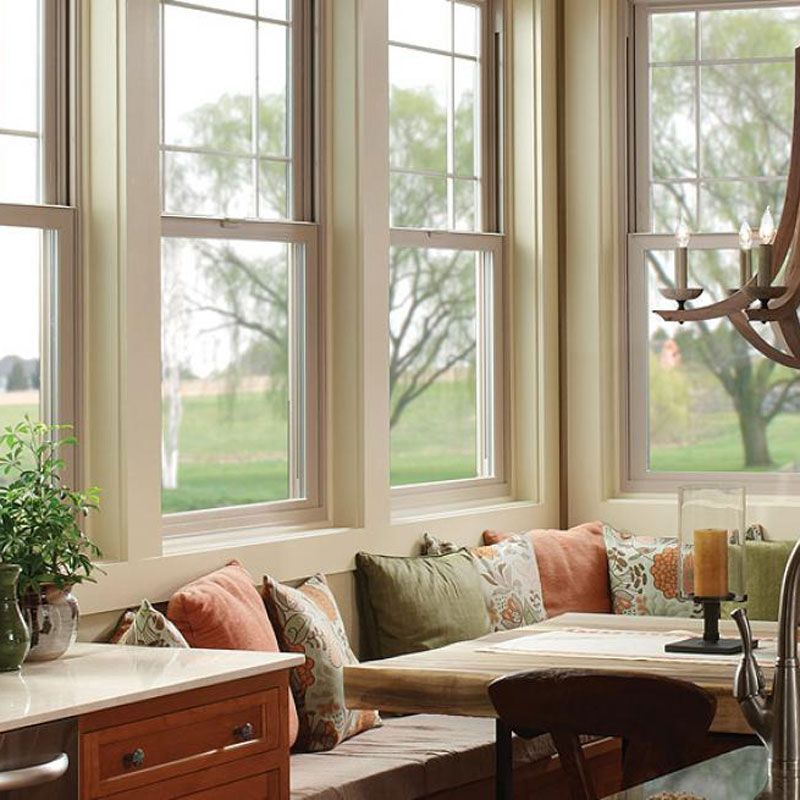 A kitchen with a bench and lots of windows A kitchen with a bench and lots of windows