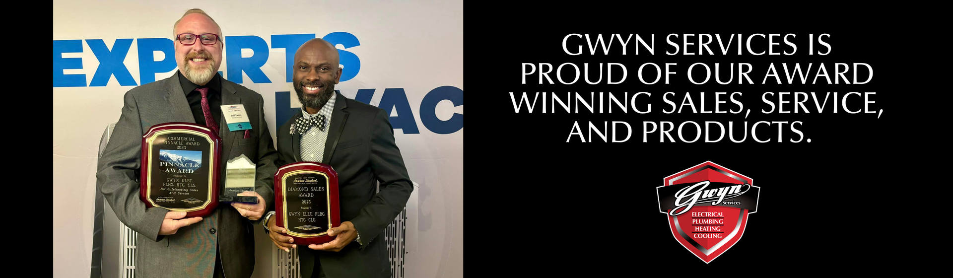 Two men holding plaques at an awards event, with “CWN Services 15 Procurement Award” text on a black background.
