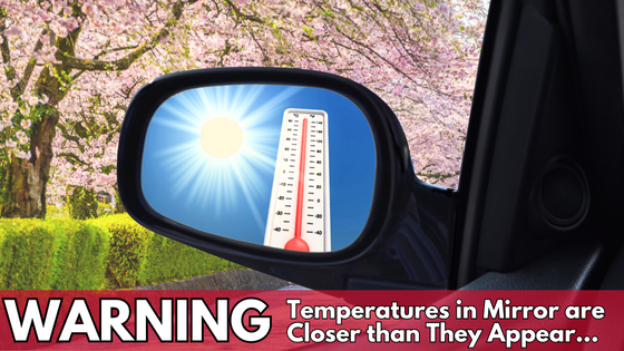 Car driving along a spring road shows summer heat in the mirror.  Warning- Temperatures in Mirror are Closer than they Appear. 