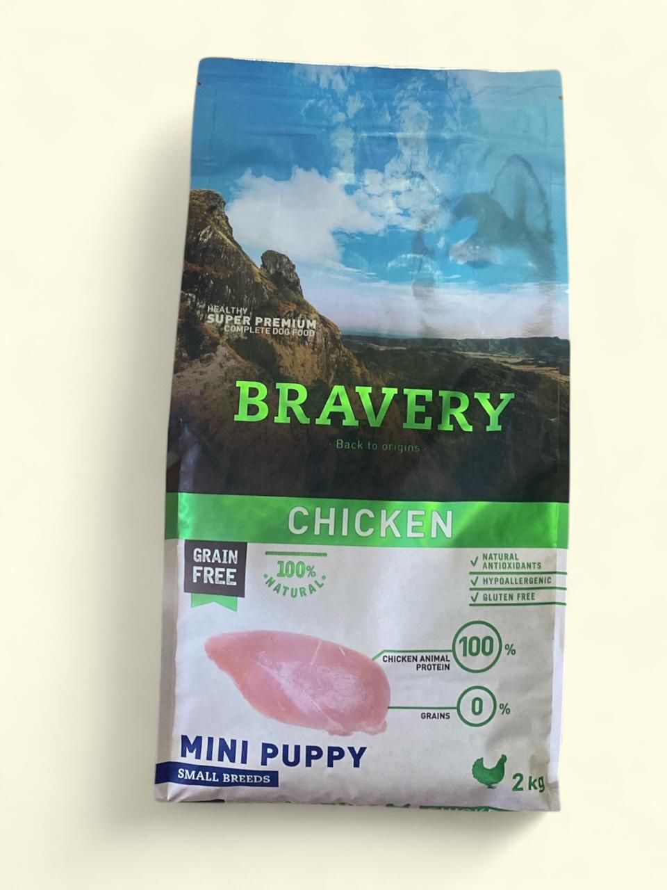 Bolsa de comida para cachorros Bravery Chicken Mini con envase verde, azul y blanco.
