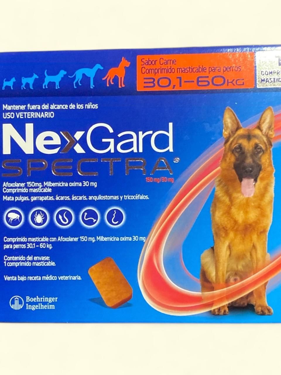 Caja de tratamiento antipulgas y desparasitación para perros NexGard Spectra, azul con etiqueta de pastor alemán y naranja.