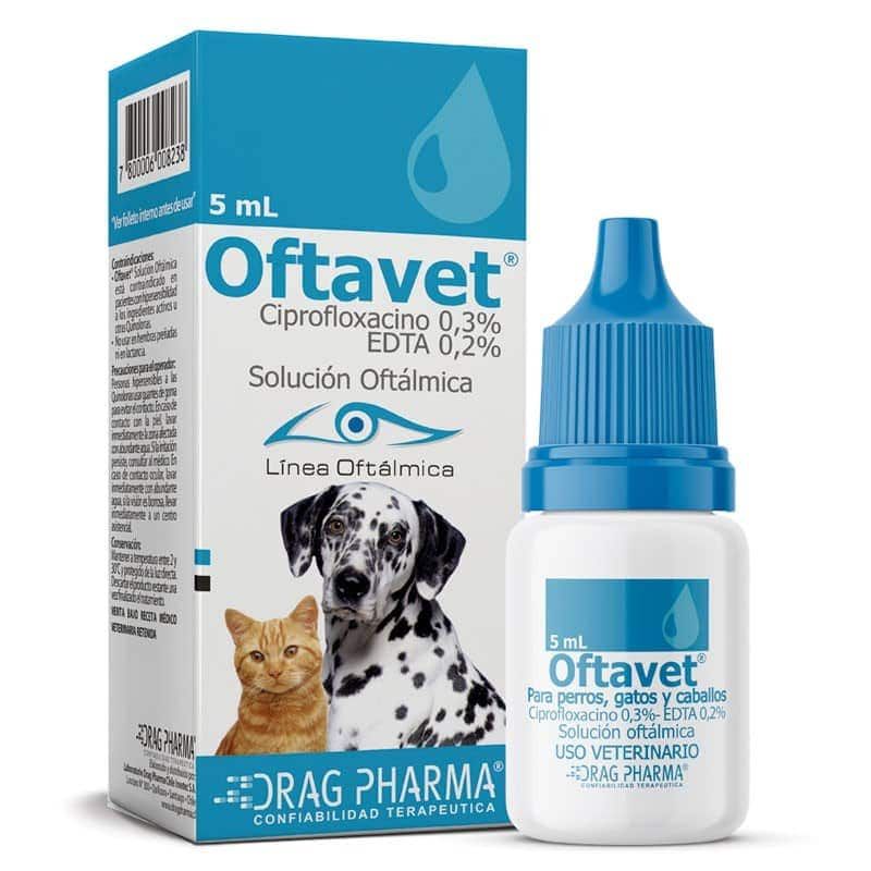 Caja y frasco de gotas oftálmicas veterinarias Oftavet de 5 ml, envase azul y blanco con imágenes de gatos y perros.