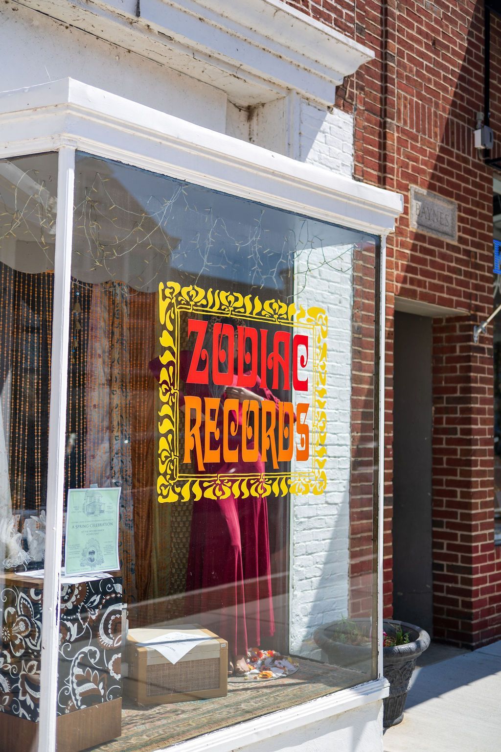 Storefront window with a bright red and yellow
