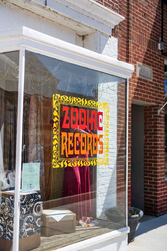 Storefront window with a bright red and yellow 